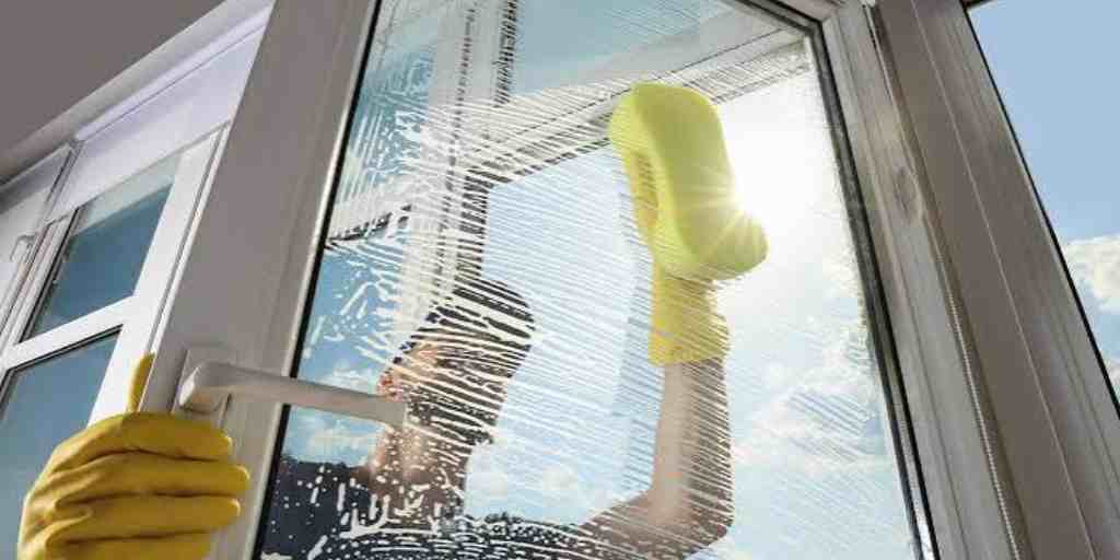 Before – shopfront window mid-clean with soap suds
