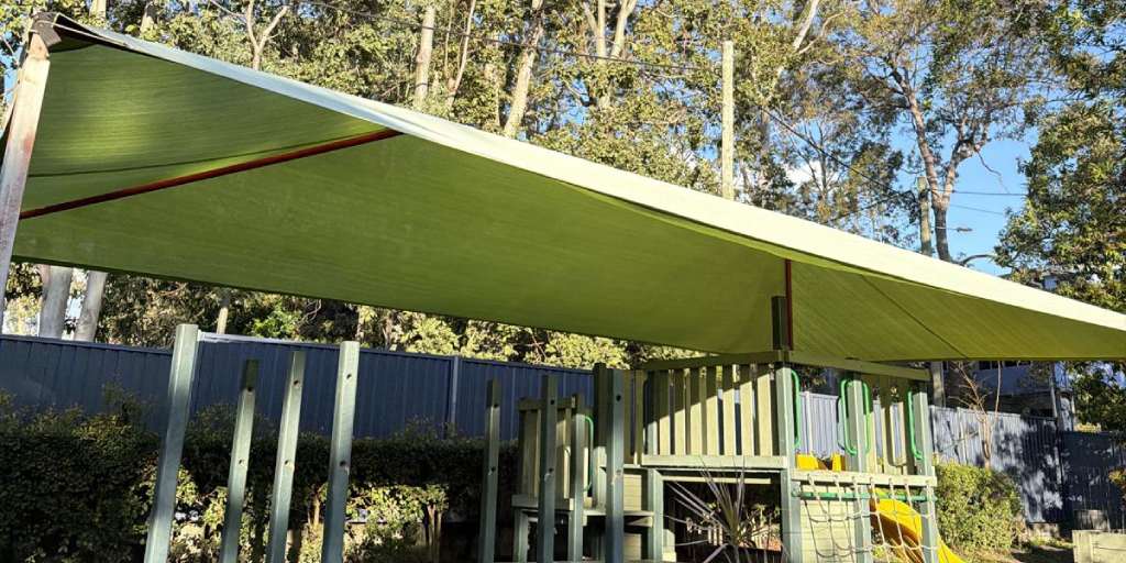 After – green outdoor park shade sail cleaned and mould treated