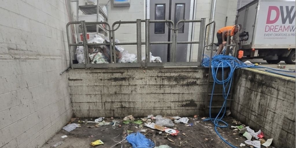 Before – loading dock waste area with heavy debris and dirty walls