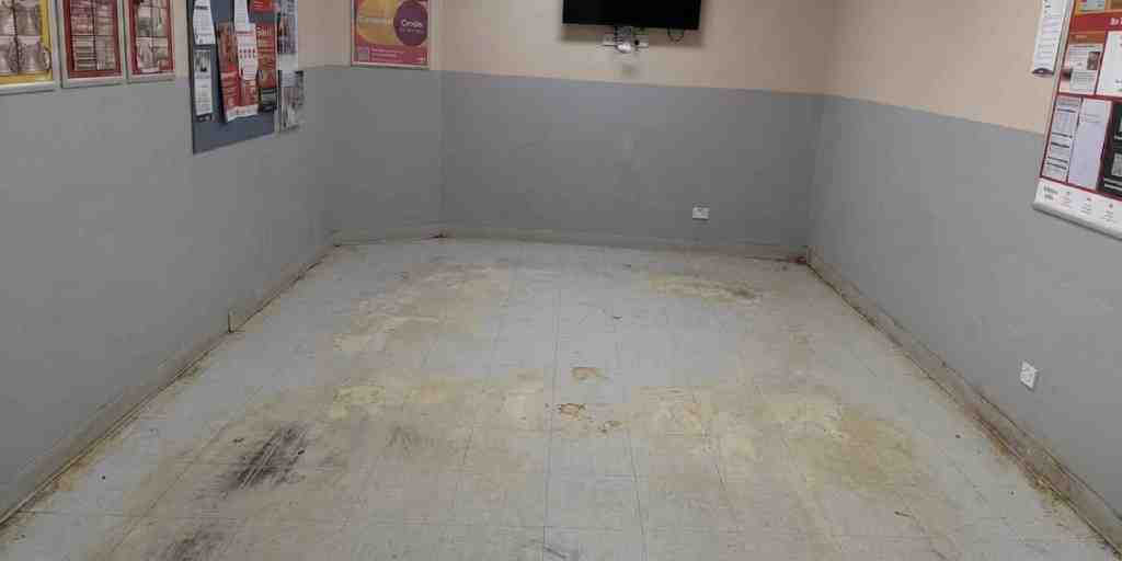 Before – staff back office vinyl tile floor heavily stained